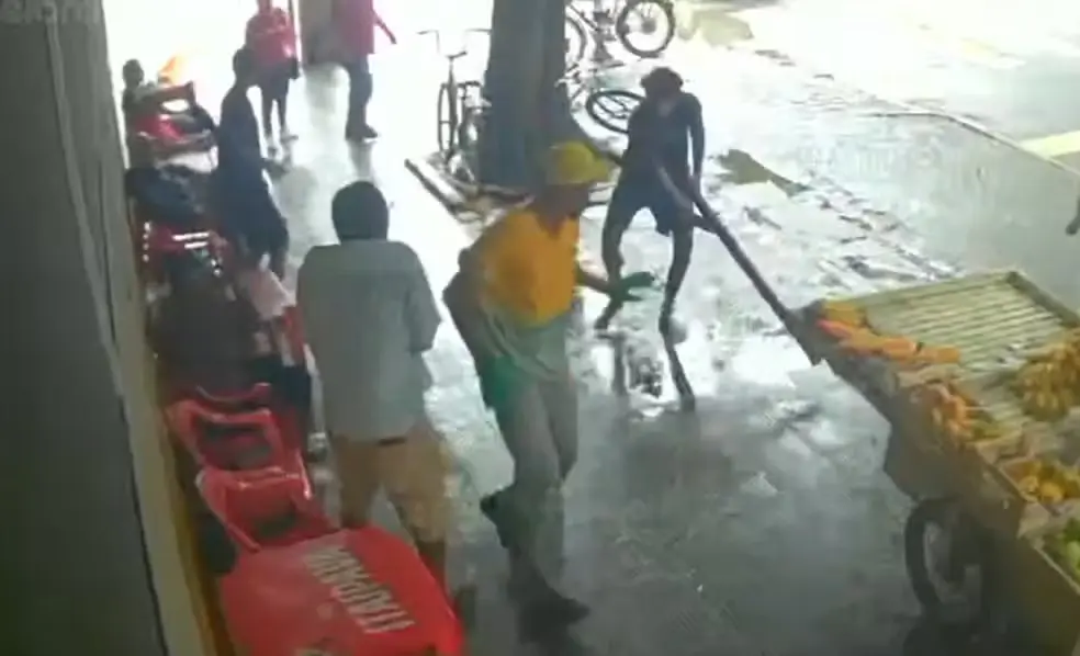 Câmeras registraram o gari correndo enquanto o homem, armado com um pedaço de madeira, o persegue e ataca na cabeça. Foto: Reprodução.