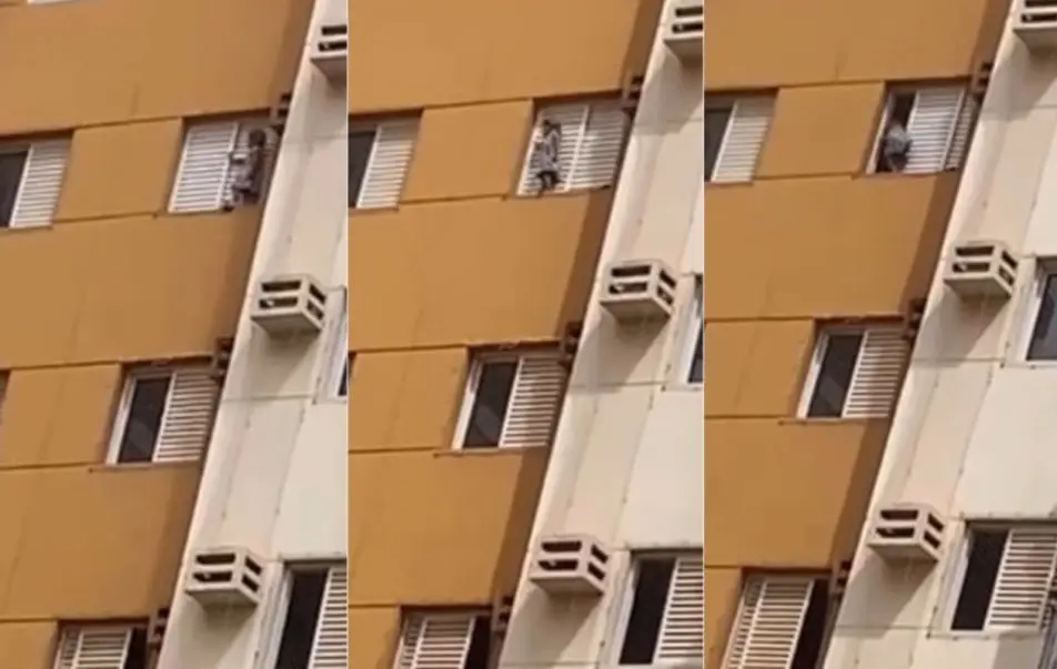 Vídeo flagra criança pendurada em janela de apartamento (Foto: Reprodução)