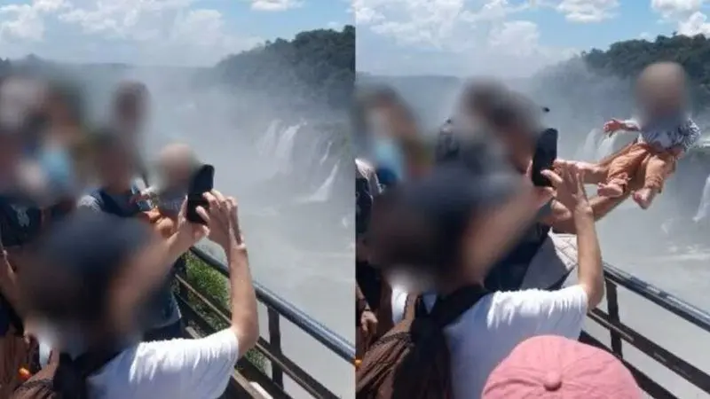 Bebê é colocado por cima das grades do mirante da Garganta do Diabo, na Argentina, enquanto adulto fotografa a ação. Foto: Reprodução/Redes Sociais.